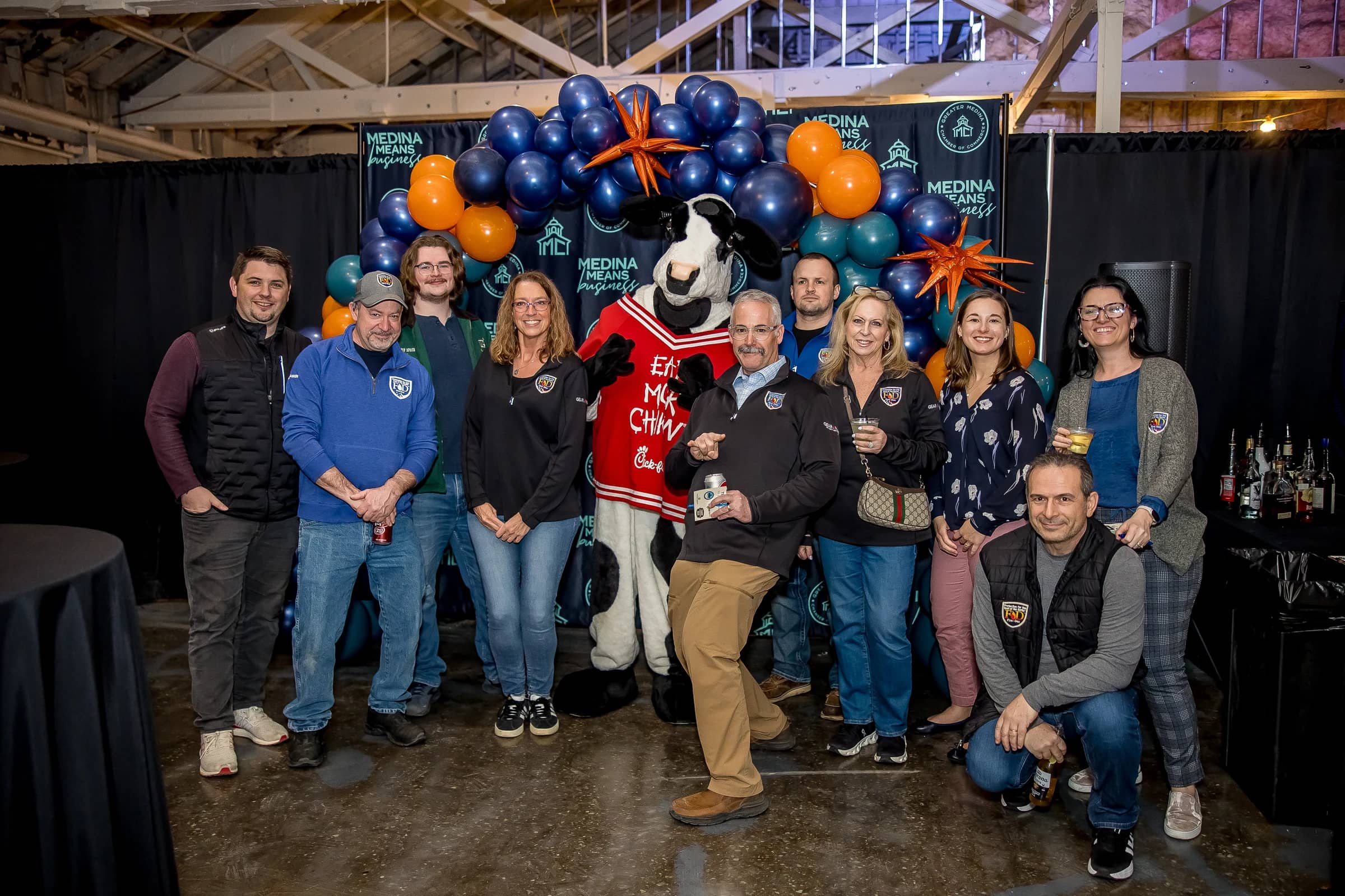 A group of attendees gathered under a balloon arch at Social Connect